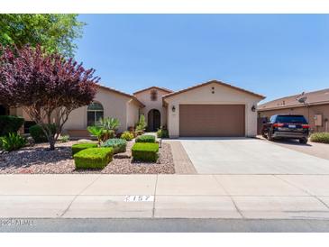 Inviting single-Gathering home featuring a desert landscape, a two-car garage, and neutral-toned stucco at 157 W Leatherwood Ave, San Tan Valley, AZ 85140