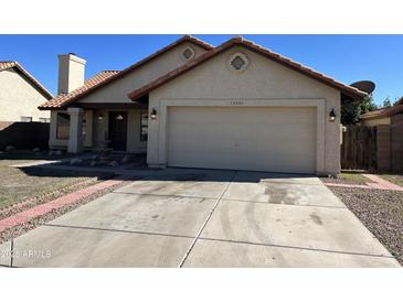 Charming single-story home with a two-car garage, manicured lawn, and inviting curb appeal at 15801 W Meade Ln, Goodyear, AZ 85338