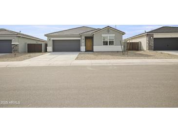 Charming single-story home featuring a gray color scheme, a two-car garage and minimalist landscaping at 17743 W Onyx Ave, Waddell, AZ 85355