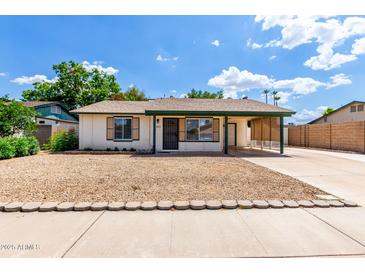 Charming single-story home with a cozy carport and a low maintenance desert landscape at 2215 W Straford Dr, Chandler, AZ 85224
