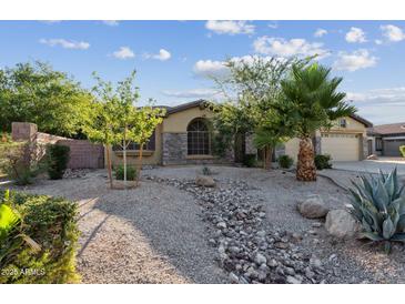 Charming single-story home with desert landscaping, river rock features, and a stone facade at 2830 S Riata Ct, Gilbert, AZ 85295