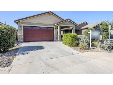 Charming single-Gathering home with a two-car garage and well-maintained landscaping at 40060 W Wade Dr, Maricopa, AZ 85138