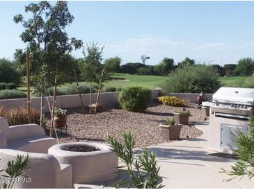 Inviting backyard featuring a fire pit, built-in seating, grill and views of the golf course at 4906 S Verbena Ave, Gilbert, AZ 85298