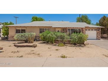 Charming single story home with a desert landscaped front yard and stone accents at 8713 E Rancho Vista Dr, Scottsdale, AZ 85251