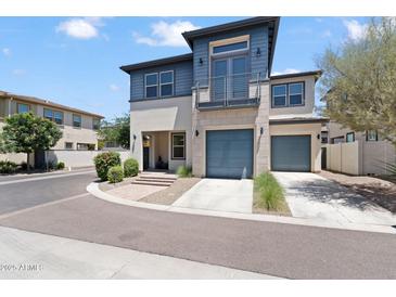 Stunning two-story home with a modern design, balcony, two-car garage, and landscaped front yard at 1555 E Ocotillo Rd # 16, Phoenix, AZ 85014