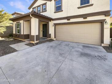 Inviting home exterior showcases a two-car garage and manicured landscaping at 16236 W La Ventilla Way, Goodyear, AZ 85338