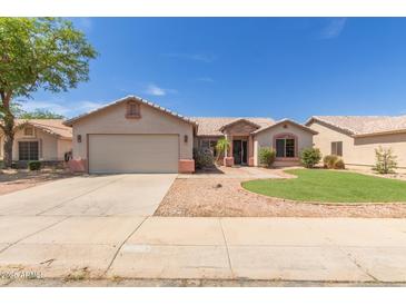 Charming single-story home with a two-car garage and low maintenance desert landscaping at 1642 E Desert Ln, Phoenix, AZ 85042