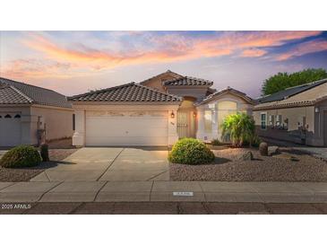 Charming single-story home with desert landscaping and a beautiful sunset backdrop at 3338 E Lavey Ln, Phoenix, AZ 85032