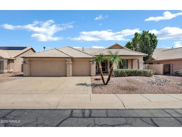 Charming single-story home with a three-car garage and well-maintained desert landscaping at 6368 W Firebird Dr, Glendale, AZ 85308