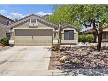 Charming single-story home with a two-car garage and desert landscaping at 11330 W Eden Mckenzie Dr, Surprise, AZ 85378