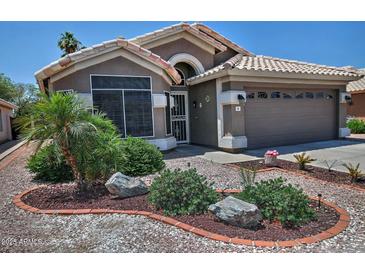 Charming single-story home with well-maintained landscaping, desert accents, and a two-car garage at 1741 S Clearview Ave # 13, Mesa, AZ 85209