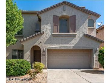 Charming two-story home featuring a stucco exterior, well-manicured landscaping, and an attached two-car garage at 2018 W Marconi Ave, Phoenix, AZ 85023
