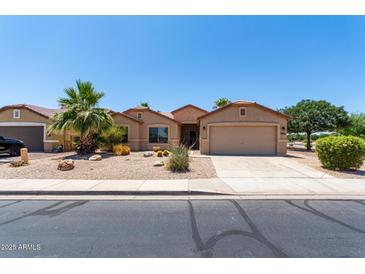 Charming single-story home featuring low-maintenance desert landscaping and a two-car garage at 43581 W Mccord Dr, Maricopa, AZ 85138