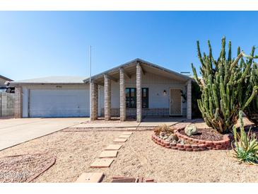 Charming single-story home featuring desert landscaping, a covered entryway, and an attached two-car garage at 4740 W Bloomfield Rd, Glendale, AZ 85304