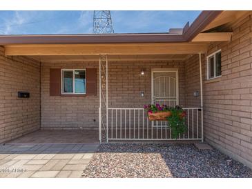 Charming front porch with decorative railing and flower box adds curb appeal at 5204 E Colby St, Mesa, AZ 85205
