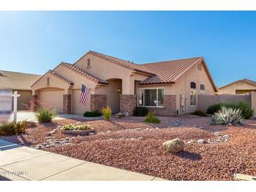 Well-maintained home boasting desert landscaping, a three-car garage, and inviting curb appeal in a lovely neighborhood at 5524 E Garnet Cir, Mesa, AZ 85206
