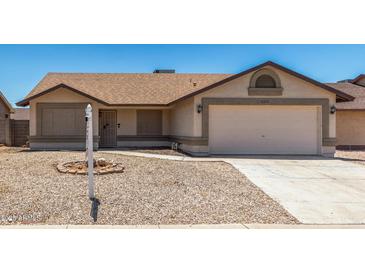 Charming single-story home with a well-maintained front yard and a two-car garage at 6317 E Colby St, Mesa, AZ 85205