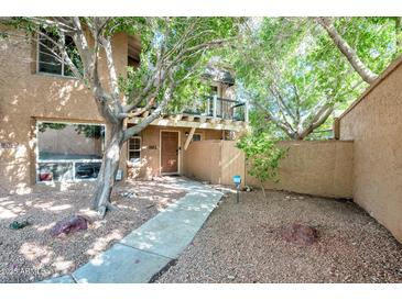 Charming home featuring a small balcony, walkway, and desert landscaping at 10424 N 7Th Pl # 2, Phoenix, AZ 85020