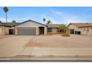 Charming brick home with desert landscaping and mature palm trees on a sunny day at 3106 S Extension Rd, Mesa, AZ 85210