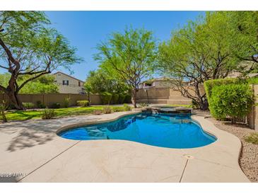 Sparkling backyard pool with lush landscaping and a serene setting, perfect for relaxation and entertainment at 3818 E Quail Ave, Phoenix, AZ 85050