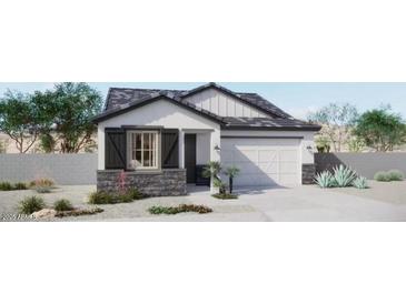 Charming single-story home boasts stone accents, a two-car garage, and an inviting, landscaped front yard at 8921 E Covina St, Mesa, AZ 85207