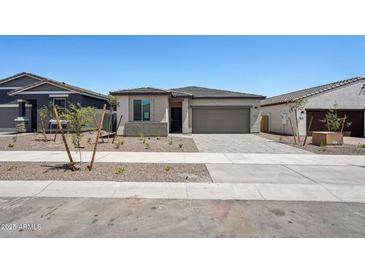 Charming single-story home featuring a two-car garage and low maintenance desert landscaping at 18248 W La Senda Dr, Surprise, AZ 85387