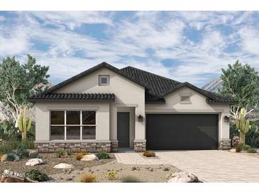 Charming single-story home with a modern design, neutral colors, dark tiled roof and a well-maintained desert landscape at 36045 N Barrel Aged Dr, San Tan Valley, AZ 85140