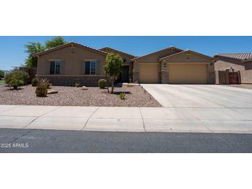 Charming single-story home with a well-manicured gravel front yard and a spacious two-car garage at 5737 W Hidalgo Ave, Laveen, AZ 85339
