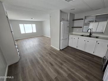 Bright living room showcasing new laminate flooring and large windows for ample natural light at 918 S Evangeline Ave, Mesa, AZ 85208
