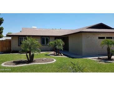 Charming single-story home featuring a well-manicured lawn and desert-friendly landscaping at 1009 E Hampton Ave, Mesa, AZ 85204