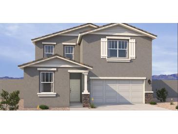 Charming two-story home with a two-car garage, stucco facade, and professionally landscaped front yard at 18265 W La Senda Dr, Surprise, AZ 85387