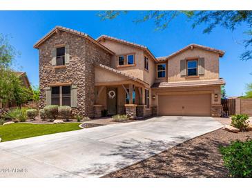 Charming two-story home featuring stone accents, a covered porch and a two car garage at 3760 W Lapenna Dr, New River, AZ 85087