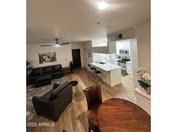 Inviting living room with modern furnishings, an open layout, and light wood-look floors at 5345 E Van Buren St # 216, Phoenix, AZ 85008