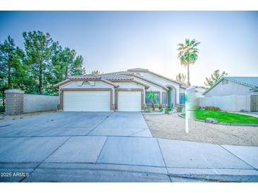 Charming single-story home featuring a well-maintained front yard, mature trees, and a two-car garage at 836 N Sinova Ave, Gilbert, AZ 85234