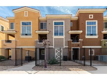 Charming townhouse exterior showcasing a gated entrance and colorful facade, offering inviting curb appeal at 22125 N 29Th Ave # 158, Phoenix, AZ 85027