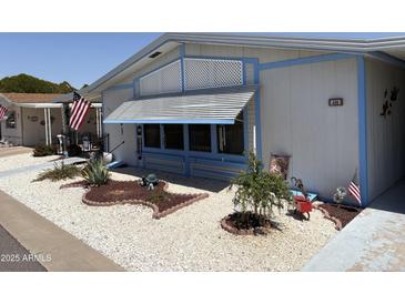 Charming home featuring lovely landscaping, decorative rock, and patriotic decorations for a warm welcome at 3330 E Main St # 430, Mesa, AZ 85213