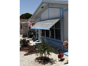 Charming home exterior with decorative landscaping and shaded awning over the windows at 3330 E Main St # 430, Mesa, AZ 85213