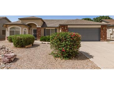 Charming single-story home featuring a low-maintenance yard, brick accents, and a two-car garage at 3646 E Rousay Dr, San Tan Valley, AZ 85140