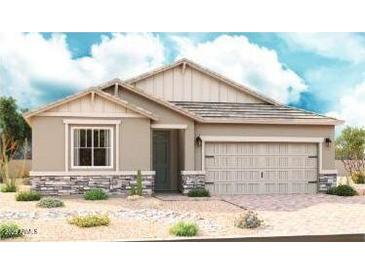 Charming single-story home featuring a two-car garage and desert landscaping at 40526 W Rio Grande Dr, Maricopa, AZ 85138