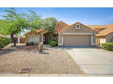 Charming single-story home featuring desert landscaping, a two-car garage, and a welcoming front entrance at 4131 E Cascalote Dr, Cave Creek, AZ 85331