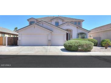 Charming two-story home with well-manicured landscaping and a spacious three-car garage at 43561 W Snow Dr, Maricopa, AZ 85138