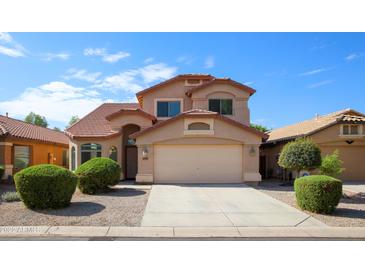 Charming two-story home featuring a well-manicured front yard and a traditional design at 44865 W Woody Rd, Maricopa, AZ 85139