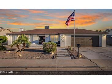 Charming single-story home featuring a landscaped front yard and an American flag at 603 W Keats Ave, Mesa, AZ 85210