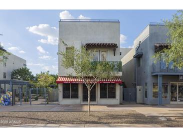Modern multi-story commercial building with a charming red and white striped awning at 610 E Roosevelt St # 145, Phoenix, AZ 85004