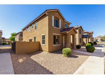 Charming two-story home featuring desert landscaping and a tile roof, offering a warm and inviting curb appeal at 917 E Agua Fria Ln, Avondale, AZ 85323
