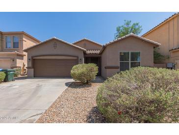 Charming single-story home featuring a two-car garage and low-maintenance desert landscaping at 10009 W Raymond St, Tolleson, AZ 85353