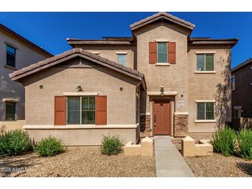 Inviting two-story home with a well-maintained front yard and charming desert landscaping at 10370 W Sands Dr # 463, Peoria, AZ 85383