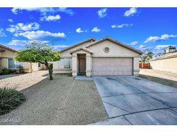 Charming single-story home featuring a low-maintenance desert landscape and a two-car garage at 4144 N 109Th Ave, Phoenix, AZ 85037