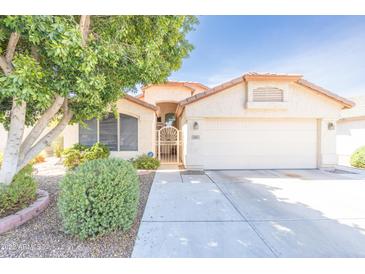 Charming single-story home features a well-maintained front yard and a two-car garage at 6415 W Escuda Rd, Glendale, AZ 85308