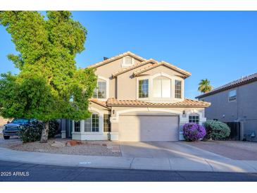 Charming two-story home with a well-manicured front yard and a two-car garage in a sunny neighborhood at 1723 E Pontiac Dr, Phoenix, AZ 85024